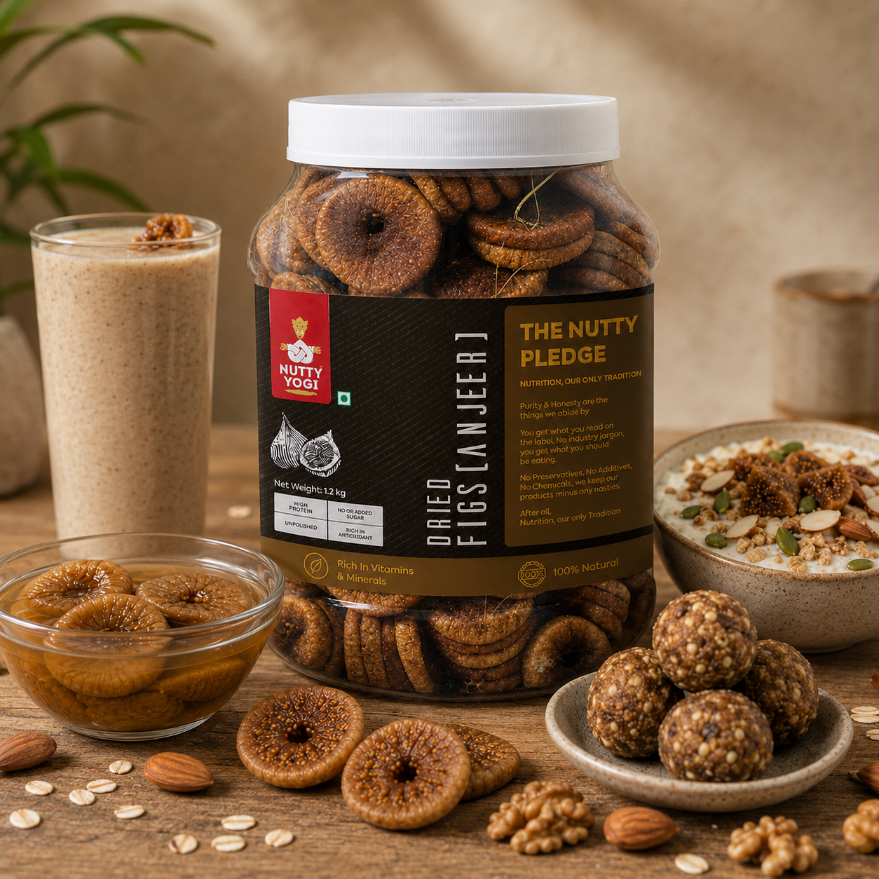A jar of Nutty Youi Dried Fig (Fisnjeer) cookies displayed on a rustic wooden table with bowls of figs, granola, and fig nut balls, alongside a glass of fig smoothie. The background is a soft beige bokeh.