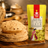 A bag of Nutty Yogi Gluten-Free SuperLite Flour stands on a wooden surface next to a stack of flatbreads, with a softly blurred kitchen background.