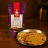 Nutty Yogi Gluten Free Multigrain Missi Atta pack with freshly cooked missi roti and fresh salad on a serving plate
