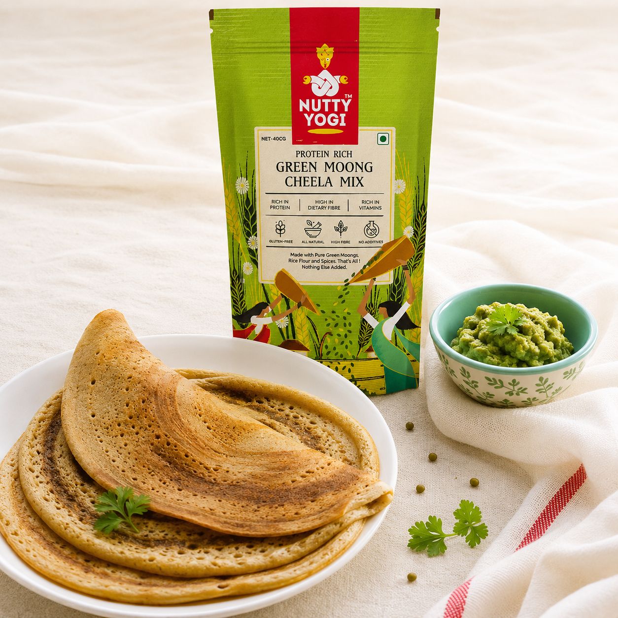 Nutty Yogi Protein Rich Green Moong Cheela Mix pouch served with freshly made green moong cheelas and green chutney.