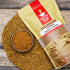 Nuty Yogi jaggery powder package with a bowl of jaggery powder on a woven mat.