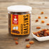 Nutty Yogi Munakka Raisins jar with premium dried raisins displayed on a wooden surface with a bowl of raisins
