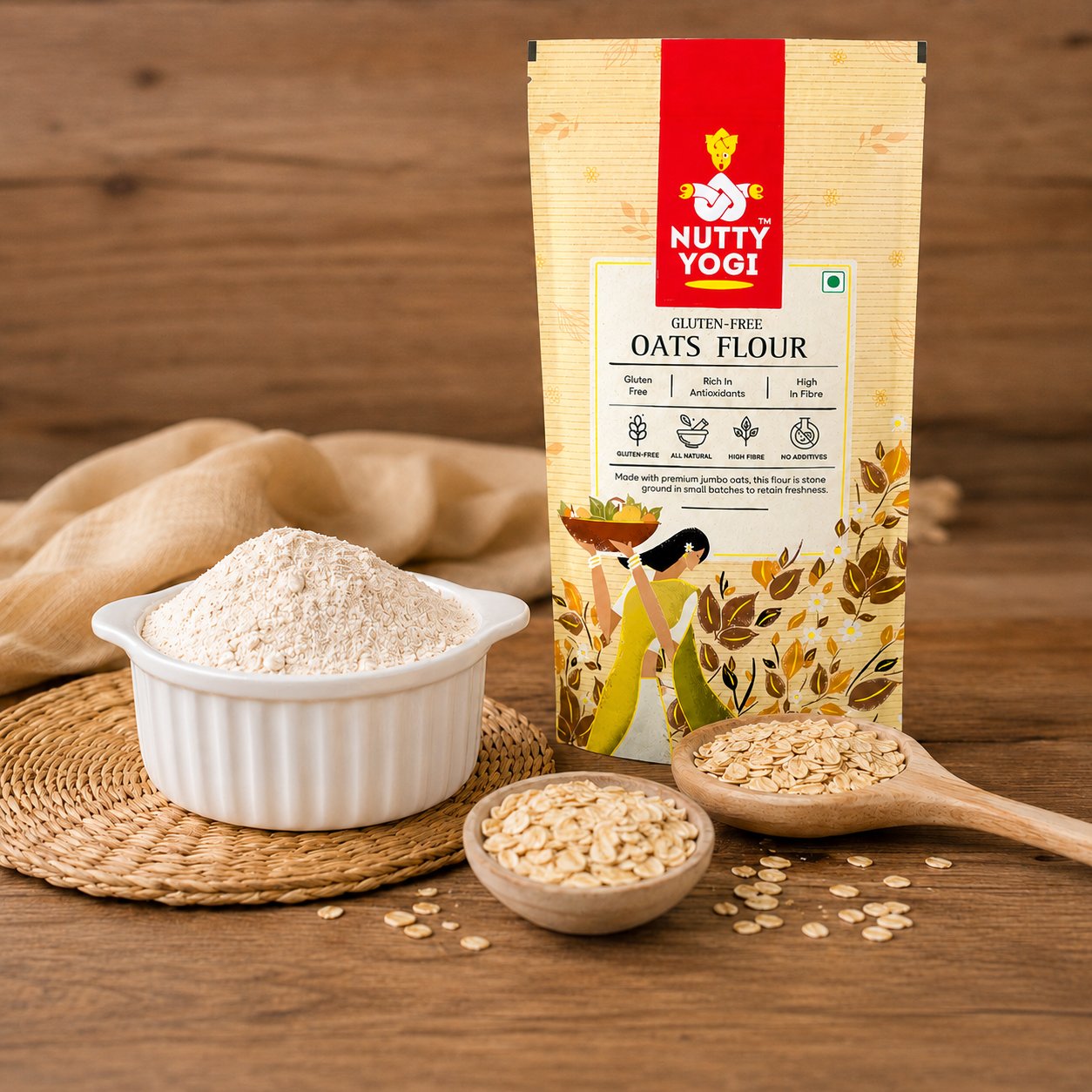 Nutty Yogi Gluten-Free Oats Flour displayed with a bowl of finely ground oat flour, whole rolled oats, and a wooden spoon, highlighting a wholesome, fiber-rich flour for everyday cooking and baking.