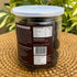 Back view of Nutty Yogi Premium Pitted Prunes jar displaying nutritional facts, ingredients, manufacturer details, barcode, and product information in clear resealable packaging.

