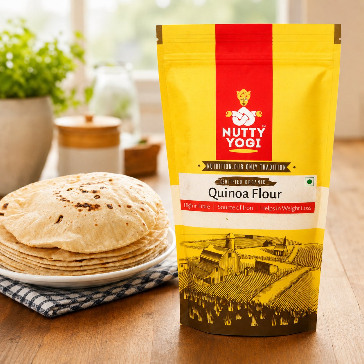 Lifestyle image of Nutty Yogi Certified Organic Quinoa Flour beside freshly puffed rotis on a wooden table, showcasing a wholesome gluten-free flour that is high in fibre, a source of iron, and suitable for everyday healthy cooking.