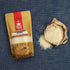 Nutty Yogi Organic Handpounded Sona Masoori Rice displayed beside a paper bag filled with premium Sona Masoori rice grains, highlighting a wholesome, naturally processed rice for everyday meals.