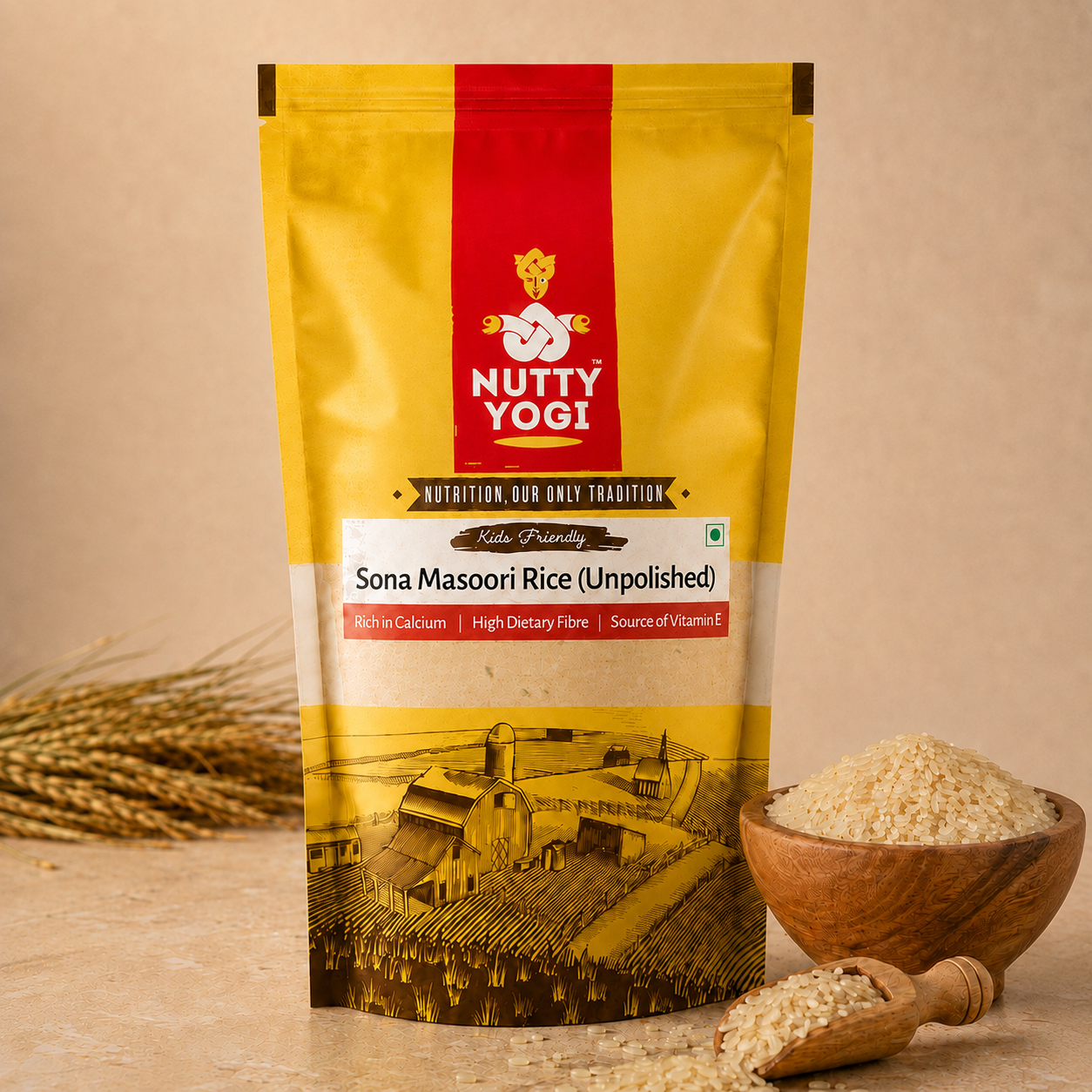 A stand-up pouch of Nutty Yog! Sona Masoori Rice (Unpolished) stands on a beige surface with a small wooden bowl and spoon of rice beside it, and wheat stalks in the background. The package is primarily yellow with a bold red vertical band and a printed illustration near the bottom.